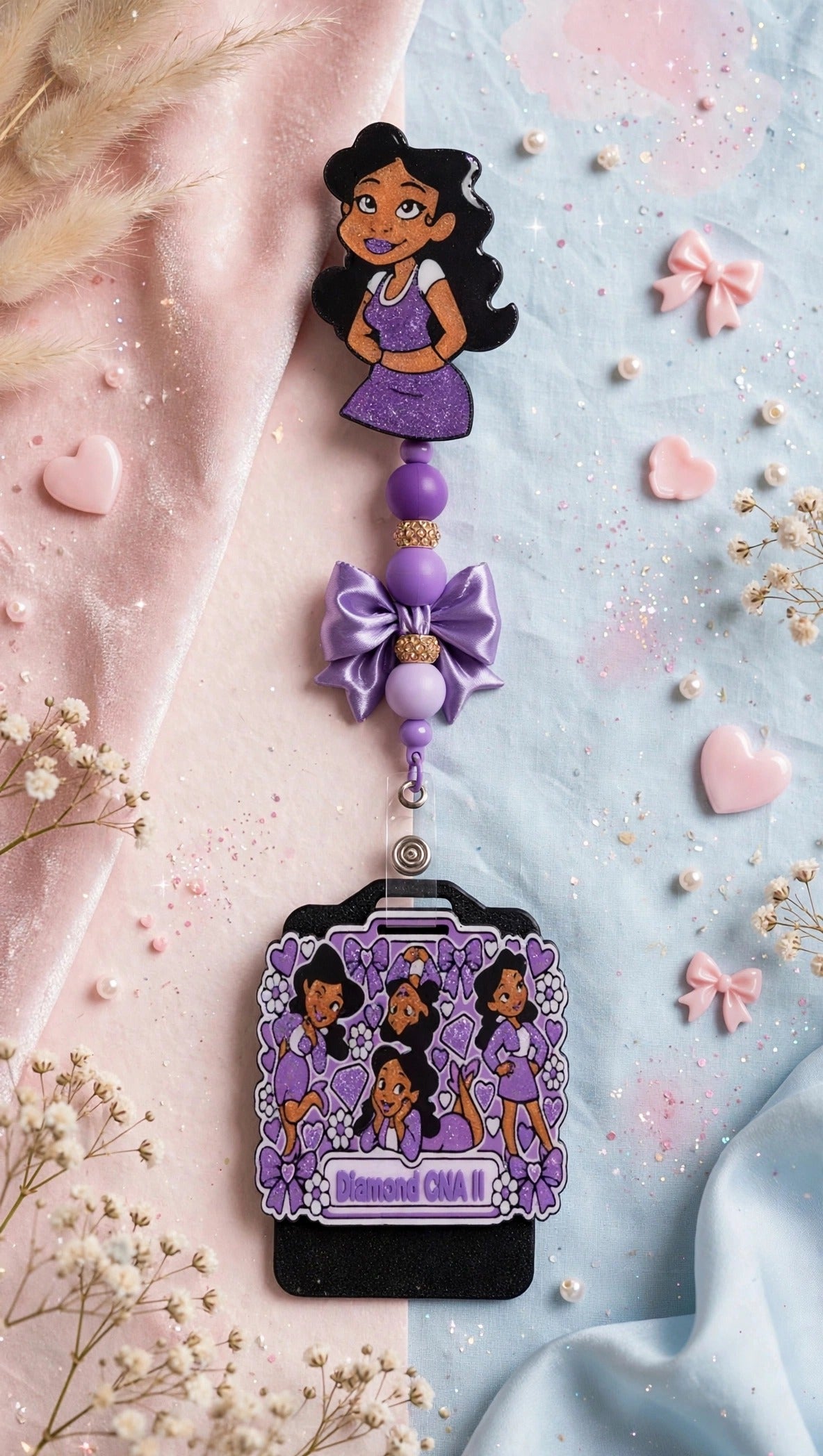 Penny Badge Reel Set in Purple — badge reel, beaded dangle with bow, and personalized badge buddy, styled on blush pink and baby blue