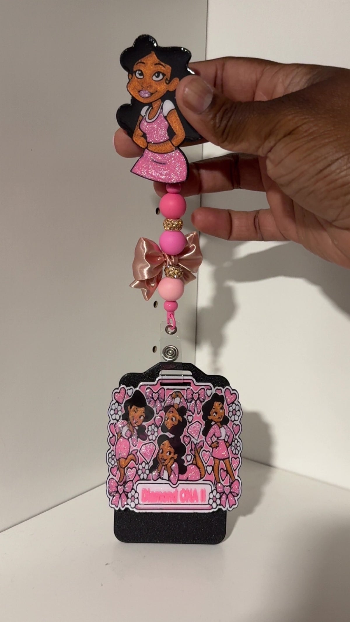 Penny Badge Reel Set in Pink shown in hand with personalized badge buddy